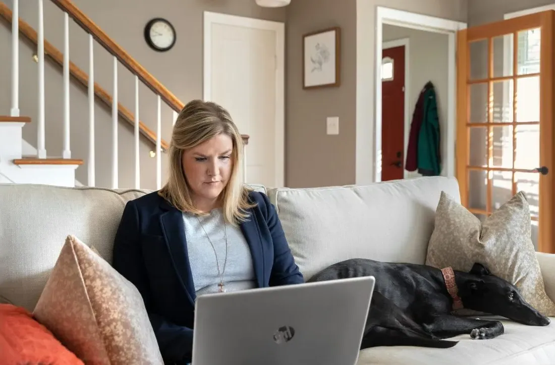 A person doing work from home on a computer.